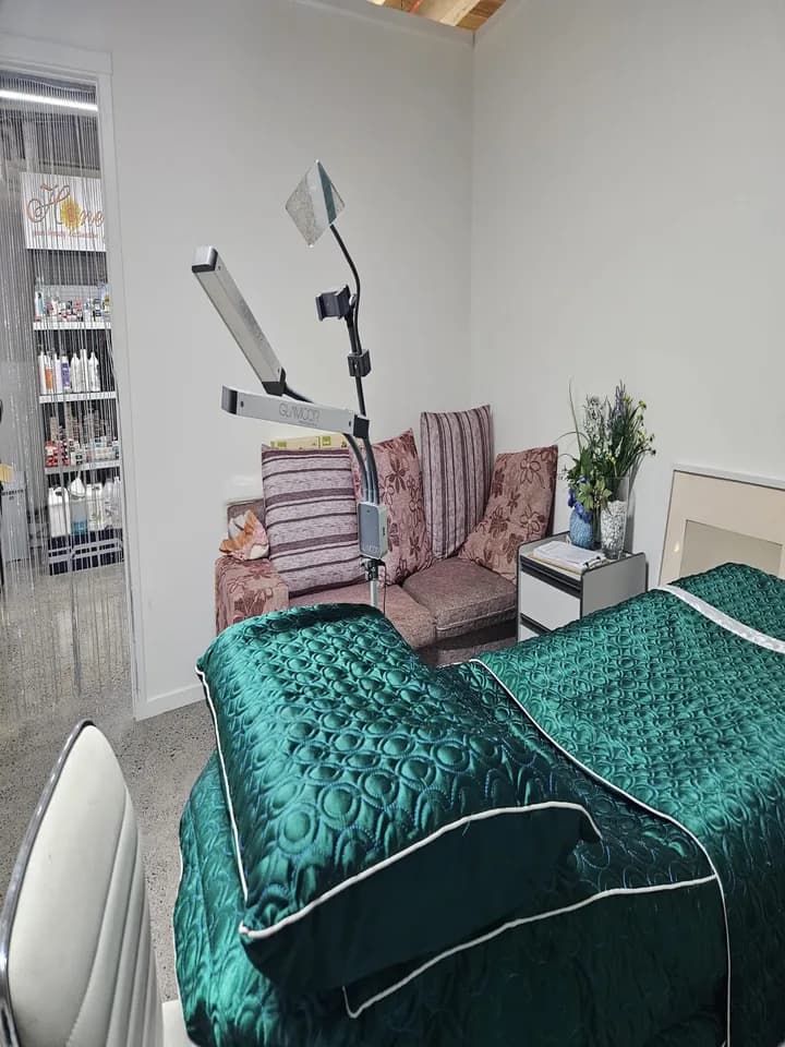 Treatment room with a facial lamp, sofa and fresh flowers