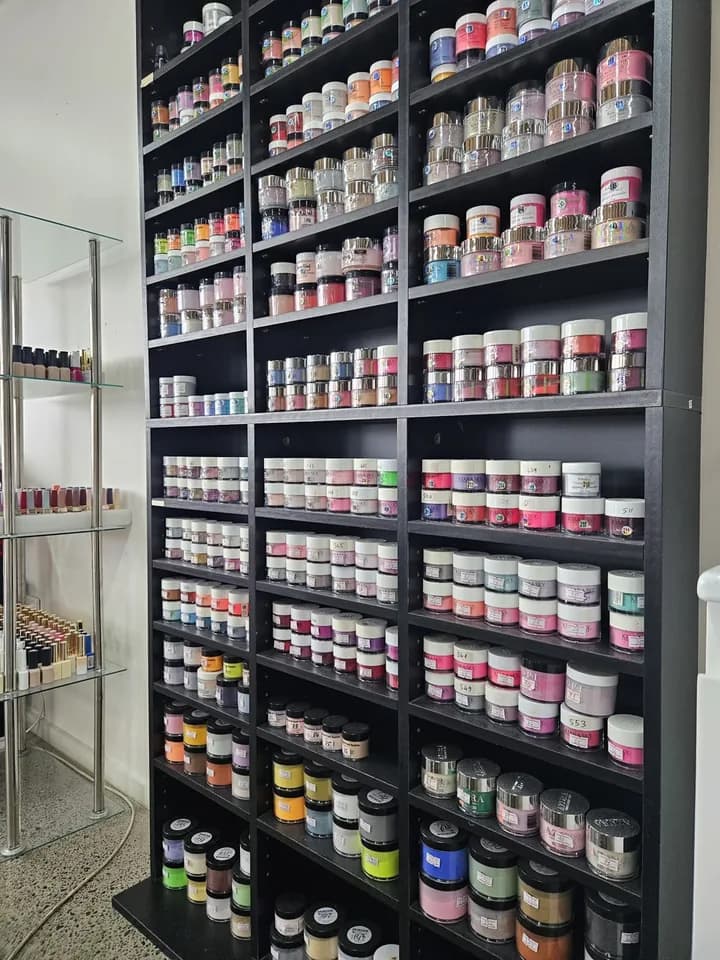 Wall of nail polish and dip powder colours