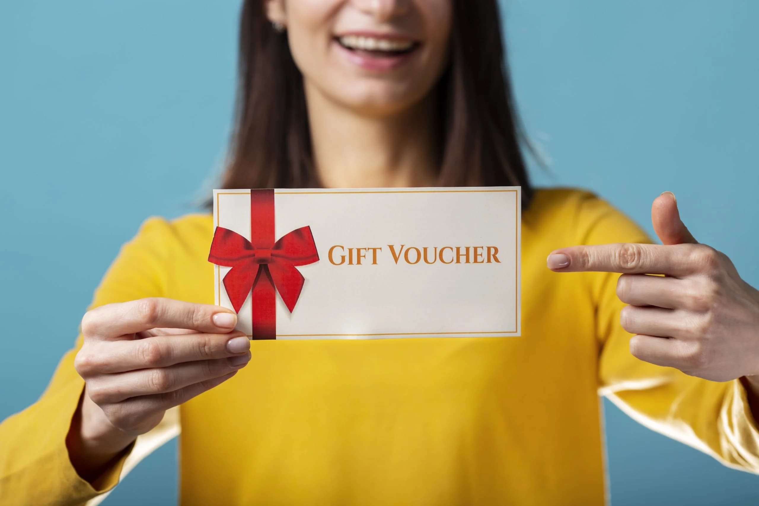 Woman holding a Honey Beauty Salon gift voucher tied with a red bow